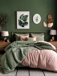 a bedroom with green walls, pink bedding and two framed pictures on the wall