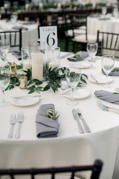 the table is set with silverware and place settings