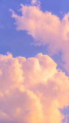 an airplane flying in the sky with clouds