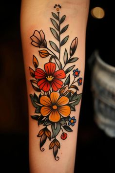 a colorful flower tattoo on the right arm and leg, with leaves and flowers around it