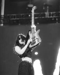 black and white photograph of a woman playing an electric guitar