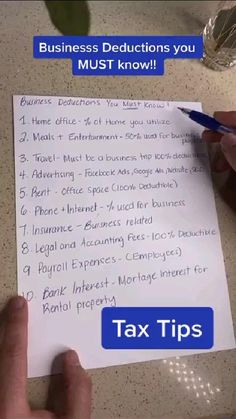 a person writing on a piece of paper with the words tax tips written below it