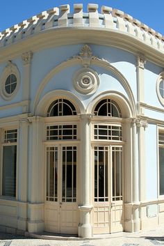 an old white building with arched windows and arches