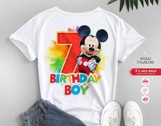 a mickey mouse birthday shirt with the number seven on it, next to a pair of jeans