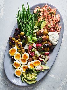 a plate filled with different types of vegetables and eggs on top of eachother