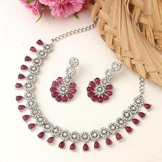 American Diamond Necklace Jewellery Set with Earrings for Women (Silver Plated Red wine)   * Material: This gold-plated jewellery set is made from Kundan, Diamond and with genuine plating, we used world-class craftsmanship.This is a party wear necklace with gold plated and alloy material, exclusive design that suits best on all types of occasions   * Quality: This beautiful jewellery set is handcrafted with good-quality material. This necklace set is comfortable to wear and perfect for any occasion like wedding ceremonies, parties, birthdays, holidays, and anniversaries   * Package Contains: This package contains a beautifully designed necklace with earrings. You can wear it with a dress, suit, or sari and lehenga for an ethnic yet classy look   * Perfect Gift: Ideal gift for someone you l Hand-set Ruby Necklaces In Silver, Red Jewelry With Elegant Design For Celebration, Elegant Red Jewelry For Celebration, Silver Jewelry Sets For Gifts With Elegant Design, Silver Jewelry Sets As Elegant Gift, Silver Jewelry Sets As Gift With Elegant Design, Elegant Silver Ruby Jewelry Sets, Ruby Jewelry Sets For Gifts, Red Sterling Silver Jewelry Sets Hand Set