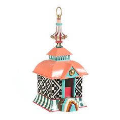 a small colorful house with a bell on top