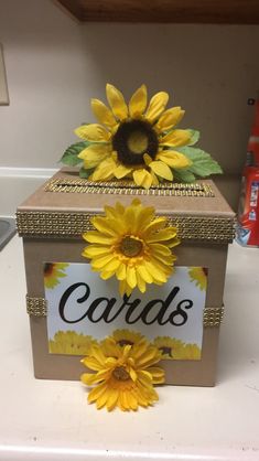 a card box decorated with sunflowers and a sign that says cards on it