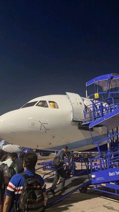 people boarding an airplane at the airport