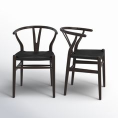 two chairs with black upholstered backrests are facing each other on a white background