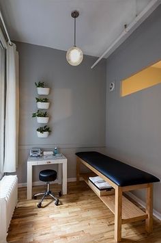 a room with a desk, chair and window