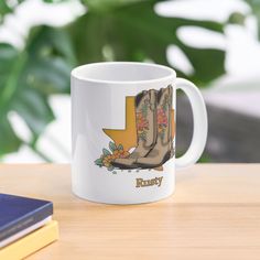 a white coffee mug sitting on top of a wooden table