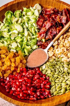 a wooden bowl filled with different types of food