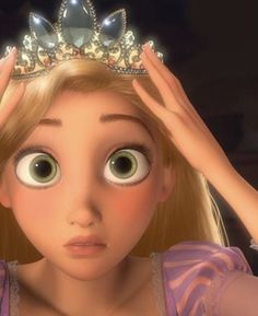 a girl with big eyes wearing a tiara