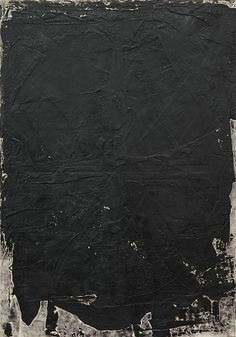 an abstract black and white painting with paint splattered on it