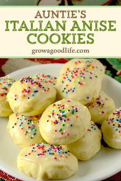 some cookies are on a plate with sprinkles and white frosting in the middle