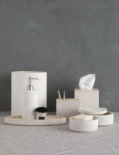 soap dispenser, toothbrush holder and other bathroom accessories on a table