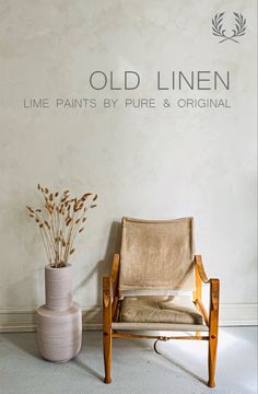 an old linen chair next to a white vase with dried plants in it and the words, old linen line paints by pure & original