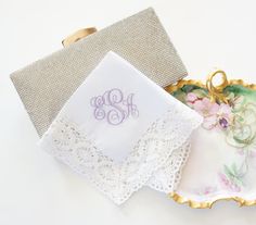 two decorative plates with monogrammed napkins on them, one for the bride and one for the groom