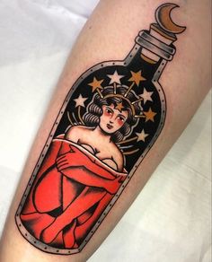 a woman in a bottle with stars and a crescent on her arm is shown from the side