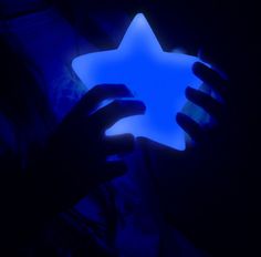 a person holding a glowing star in their hands