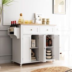 a white cabinet with wine bottles and other items on it in a living room area