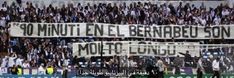 there are many fans in the stands holding up banners for their team's soccer match