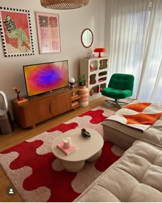 a living room filled with furniture and a flat screen tv on top of a wooden stand