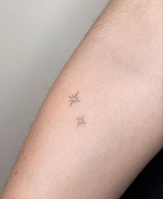 a small star tattoo on the arm