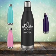 three stainless steel water bottles sitting on top of a wooden table with the words i run on coffee, chaps and cuss words