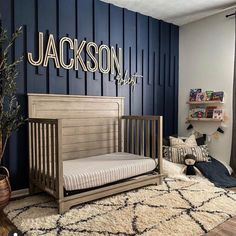 a baby's room with blue walls and wooden furniture