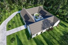 an aerial view of a house with solar panels on it's roof and driveway