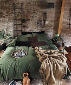 a bed room with a neatly made bed next to a brick wall and potted plants