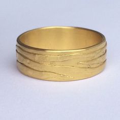 a close up of a gold ring on a white background