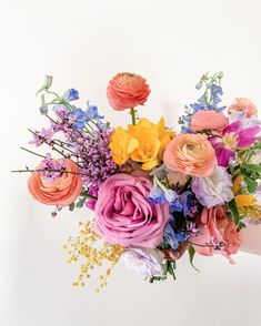 a person holding a bouquet of flowers in their hand