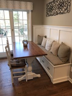 a kitchen table and bench with storage underneath it