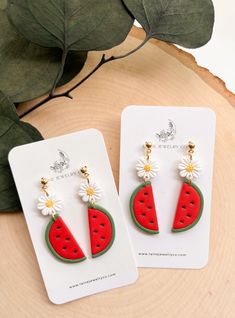 the watermelon earrings are decorated with daisies