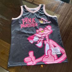 “The Pink Panther” Basketball Jersey By Headgear Classics Size: Medium Colors: Black And Pink New Without Tags! Pink Sleeveless Top For Streetwear, Pink Panthress, Pink Out Shirts Basketball, Pink Graphic Print Sports Top, Pink Panther Jacket, Black Panther Jersey, Pink Panther Clothes, Pink Panthers, Basketball Jersey