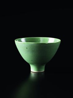 a white bowl sitting on top of a black table