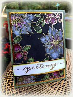 a close up of a greeting card on a table with flowers and grass in the background