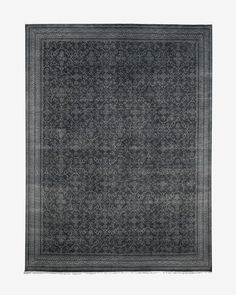 a gray rug with an intricate design on the top and bottom, against a white background