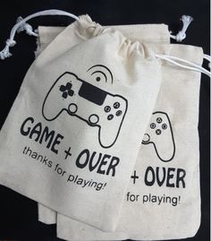 two drawsack bags with game over and playing printed on the front one has a video game controller in it