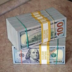 two stacks of money sitting on top of each other