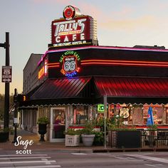 a restaurant called roll's cafe is lit up at dusk