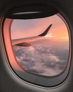 the view from inside an airplane window at sunset