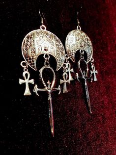 Vampire Ankh Cathedral Earring. - Available in 2 styles. - Stunning vampire ankh. (6cmx3cm) - 2 Small Ankhs - Moon Cathedral-like ornament. Style 1: With connector above the big vampire ankh. Style 2: Without connector above the big vampire ankh. Worldwide Shipping More jewellery, accesoires, altar equipment and much more can be found at www.luciferothica.com © Luciferothica.com All Rights Reserved. Cathedral Earrings, Vampire Ankh, Vampire Earrings, Ankh Symbol, Gothic Jewellery, Ankh Necklace, Goth Accessories, Dark Jewelry, Edgy Earrings