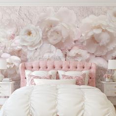 a bedroom with pink and white flowers on the wall