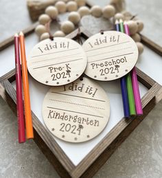 three personalized wooden tags with colored pencils