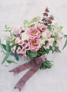 a bouquet of flowers on a white surface