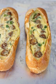 two breads with sausage and cheese on them